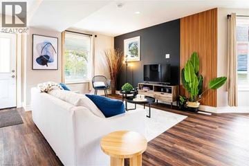 Stratford apartment for rent - A living room with a white couch and a wooden table.