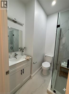 Hamilton apartment for rent - A bathroom with a sink, toilet, and shower.