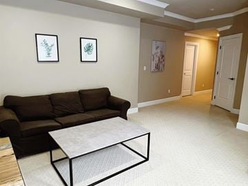 Surrey apartment for rent - A living room with a brown couch and a coffee table.