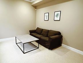 Surrey apartment for rent - A brown couch sits in a room with a coffee table in front of it.