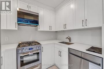 Toronto (Forest Hill South) apartment for rent - A white kitchen with a stove top oven and a dishwasher.