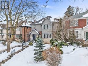 Toronto (Forest Hill South) apartment for rent - A house with a snow-covered front yard.