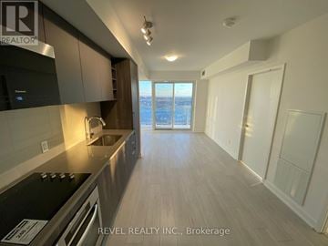 Toronto (Agincourt South-Malvern West) condo for rent - A kitchen with a stove top oven and a microwave.