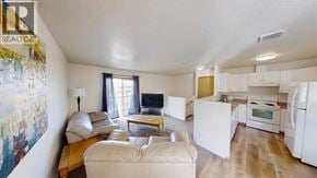 Grande Prairie apartment for rent - A living room with a couch, a table, and a painting on the wall.