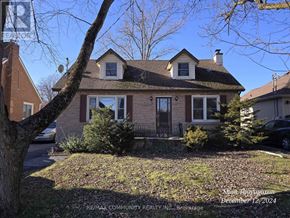 Niagara Falls (West Wood) apartment for rent - A house with a red roof and a tree in front of it.