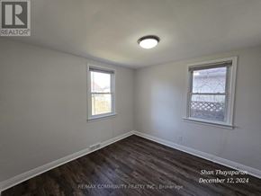 Niagara Falls (West Wood) apartment for rent - A room with a window and a wooden floor.