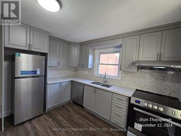 Niagara Falls (West Wood) apartment for rent - A kitchen with a stainless steel refrigerator and cabinets.