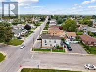 St. Catharines (Burleigh Hill) apartment for rent - A residential street with houses on both sides and cars parked on the side of the road.