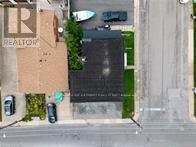 St. Catharines (Burleigh Hill) apartment for rent - A realtor sign is on the side of a building.