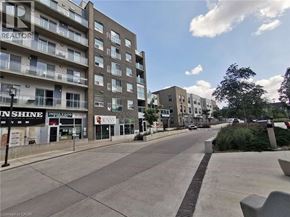 Waterloo condo for rent - A street view of a residential area with apartment buildings and shops.