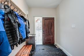 Blue Mountains townhouse for rent - A hallway with a bench and jackets hanging on a rack.