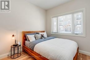 Blue Mountains townhouse for rent - A bedroom with a bed, nightstand, and window.