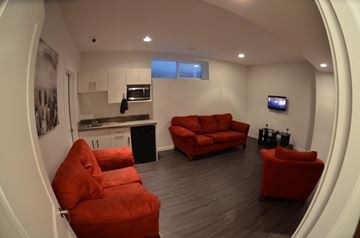 Saskatoon apartment for rent - A living room with a red couch and a television.