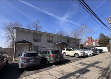 Morgantown apartment for rent - A row of cars parked in front of a building on a sunny day.