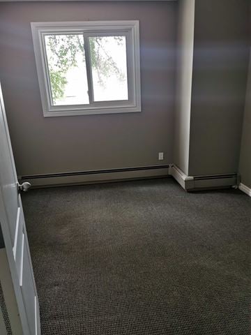 Saskatoon apartment for rent - A room with a window and carpeted floor.