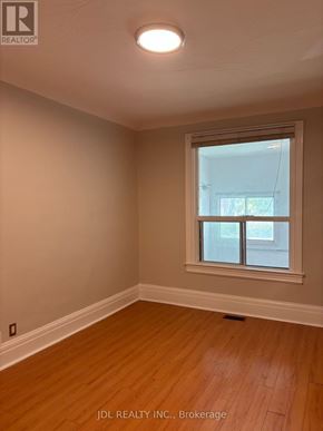 Toronto (University) apartment for rent - A room with a window and wooden flooring.