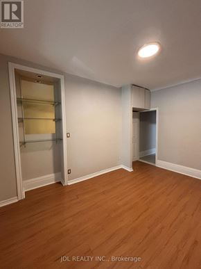 Toronto (University) apartment for rent - A room with wooden floors and white walls, with a door on the left and a closet on the right.