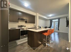 Haldimand townhouse for rent - A kitchen with a bar stool and a window.