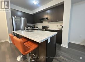 Haldimand townhouse for rent - A kitchen with a table and chairs in front of it.