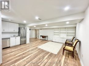 Niagara-On-The-Lake (Town) apartment for rent - A spacious kitchen with white cabinets and a wooden floor.