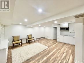 Niagara-On-The-Lake (Town) apartment for rent - A well-lit room with two chairs and a rug.