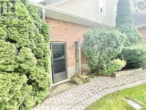 Niagara-On-The-Lake (Town) apartment for rent - A house with a grey door and a brick wall.
