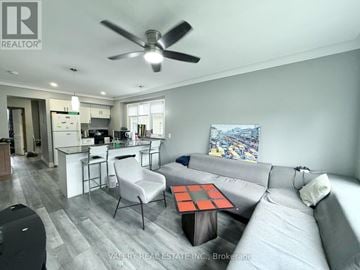 Windsor apartment for rent - A living room with a grey couch and a black and white rug.