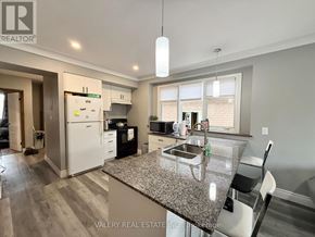 Windsor apartment for rent - A kitchen with a granite countertop and a white refrigerator.
