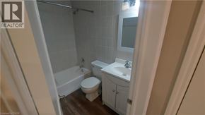 Kitchener apartment for rent - A bathroom with a toilet, sink, and shower.