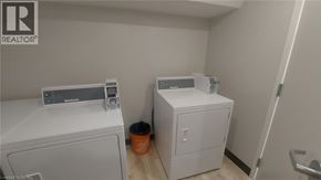 Kitchener apartment for rent - A laundry room with a washer and dryer.