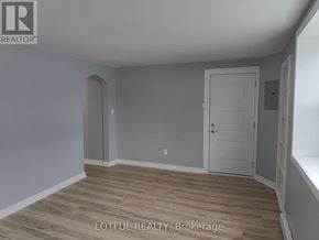 Elizabethtown-Kitley fourplex for rent - A room with wooden flooring and a white door.