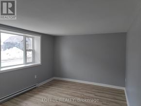 Elizabethtown-Kitley fourplex for rent - A room with a window and wooden flooring.