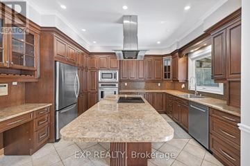 Newmarket (Stonehaven-Wyndham) apartment for rent - A kitchen with wooden cabinets and a marble countertop.