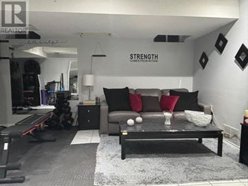 Brampton (Bram East) apartment for rent - A living room with a grey couch and a black coffee table.