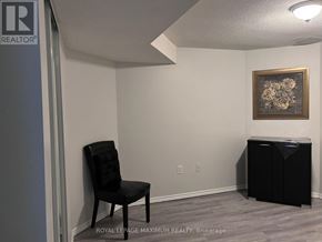 Brampton (Bram East) apartment for rent - A room with a door, a picture on the wall, and a shelf with a basket on it.