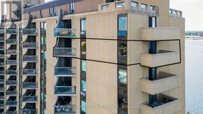 Sarnia condo for rent - A building with balconies and a body of water in the background.