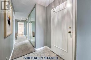 Sarnia condo for rent - A hallway with a white door and a carpet on the floor.