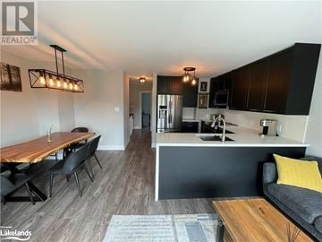 Blue Mountains townhouse for rent - A modern kitchen with a dining table and chairs.