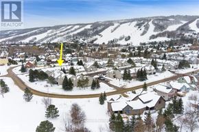 Blue Mountains townhouse for rent - A snowy landscape with a yellow arrow pointing to a house.