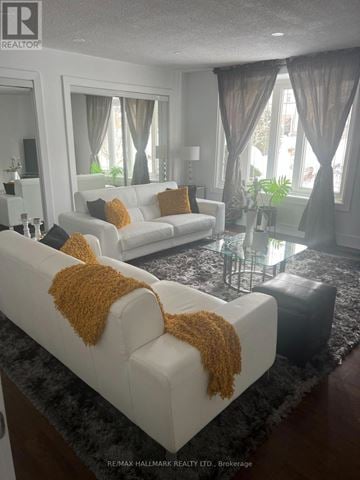 Markham (Thornhill) apartment for rent - A living room with two white couches and a glass coffee table.