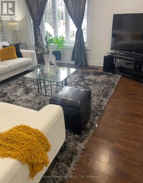 Markham (Thornhill) apartment for rent - A living room with a white couch and a glass coffee table.