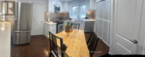 Markham (Thornhill) apartment for rent - A kitchen with a table and chairs in the middle of it.