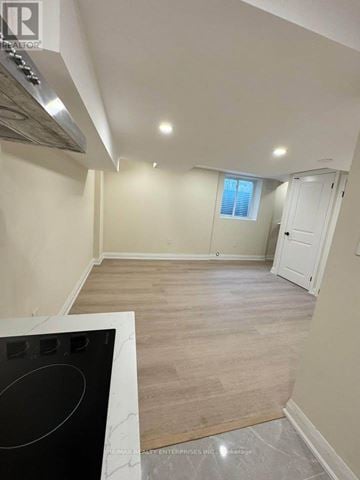 St. Catharines (Carlton/Bunting) apartment for rent - A kitchen with a black stove top oven and wooden flooring.
