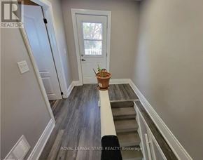 Hamilton (Crown Point) apartment for rent - A hallway with a door and a plant on the steps.