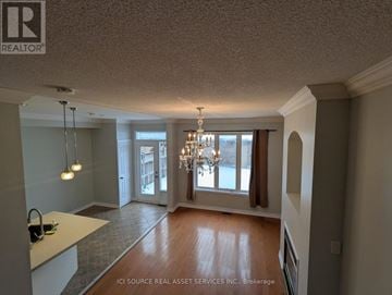 Markham (Greensborough) apartment for rent - A well-lit room with a chandelier and a kitchen counter.