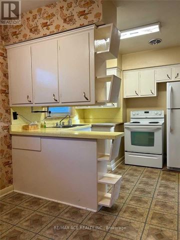 Toronto (Woburn) apartment for rent - A kitchen with white cabinets and a yellow counter.