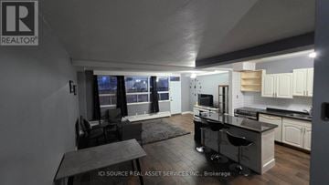 Hamilton (Vincent) townhouse for rent - A modern kitchen with a dining table and chairs.