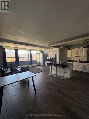 Hamilton (Vincent) townhouse for rent - A living room with a couch, chair, and a rug.