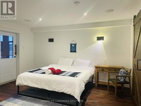Niagara Falls (Chippawa) apartment for rent - A bedroom with a bed, desk, chair, and a window.