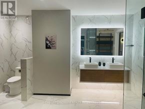 Niagara Falls (Chippawa) apartment for rent - A bathroom with a marble wall and a toilet.